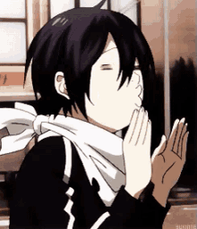 a cartoon character with a scarf around his neck is praying with his eyes closed