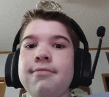 a young boy wearing headphones and a microphone on his head