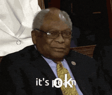 a man in a suit and tie says " it 's ok " in white letters
