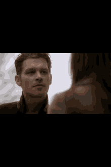 a man and a woman are looking at each other with the name nathaniel buzzard in the corner