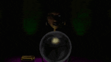 a woman is sitting at a table in front of a crystal ball .