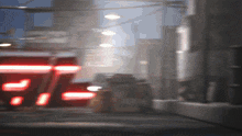 a blurred image of a street with a red sign that says ' r ' on it