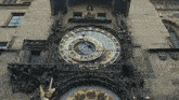 a large clock on the side of a building has the hands on the numbers 1 and 2