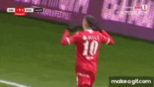a soccer player wearing a red jersey with the number 10 on the back