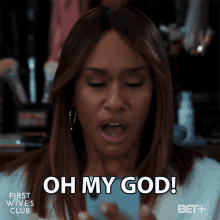 a woman is holding a cell phone and says oh my god