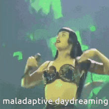 a woman singing into a microphone with the words maladaptive daydreaming written below her
