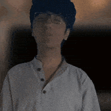 a man wearing glasses and a white shirt