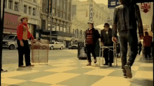 a man walking down a street with a sign that says paula