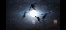 a group of people are flying through the air in front of a bright light