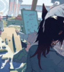 a pixel art drawing of a woman sitting in front of an easel with a ponytail .