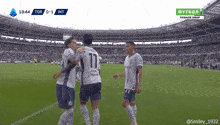 a group of soccer players on a field with the number 11 on their jersey