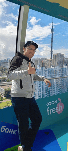 a man giving a thumbs up in front of a sign that says fresh