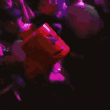 a person wearing a red marshmello mask is dancing in a crowd of people