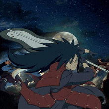 a samurai with long hair is holding a sword in his hand .