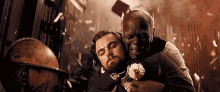 a man is sleeping on a man 's back in a room .