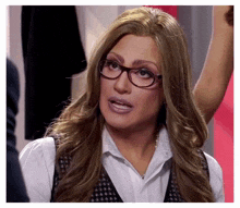 a woman wearing glasses and a white shirt is looking at the camera