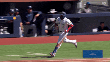 a baseball player for the blue jays is running on a field
