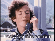 a man is talking on a phone and says becky 's a fine person !