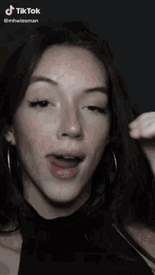 a woman 's face is shown in a tiktok video taken by mhwiesman