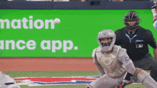 a baseball game is being played in front of a green sign that says nation