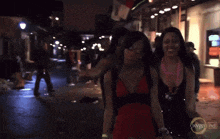 three women are walking down a street with oxygen hd written on the bottom right