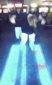 a person is dancing on a lighted floor