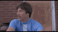 a man in a blue shirt says right on in white letters