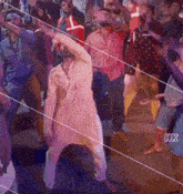 a group of people are dancing with the letters hk on the bottom right