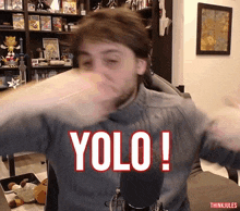 a man is making a funny face with the word yolo on his chest