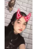 a girl with devil horns on her head is wearing a black shirt that says ' i love you ' on it