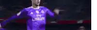 a soccer player is wearing a purple fly emirates jersey and celebrating a goal .