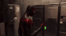 a man in a superhero costume is standing in front of a locker