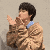 a person blowing a kiss with their hands