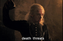 a person holding a sword with the words death threats written on the bottom