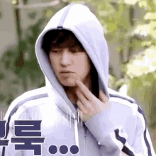 a close up of a person wearing a hoodie with chinese writing on it .