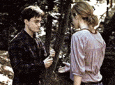 a man and a woman are standing in the woods