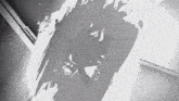 a black and white photo of a person 's shadow on a wall