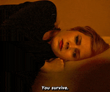 a woman laying on a bed with the words " you survive " below her