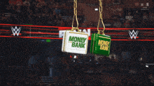 a crowd watching a wrestling match with a sign that says money bank on it