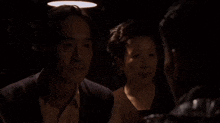 a man and woman are talking to each other in a dark room .