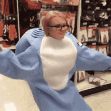 a woman in a shark costume is standing in a store .