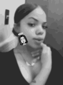 a black and white photo of a woman wearing a necklace and earrings