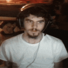 a man wearing headphones and a white t-shirt