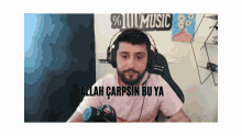 a man wearing headphones with the words allah carpsin bu ya written below him
