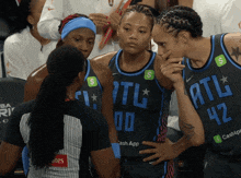 a group of female basketball players with atl on their jerseys