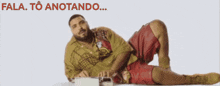 a man is laying on the floor with the words fala to anotando behind him
