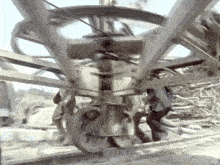 a group of people are standing around a large metal structure