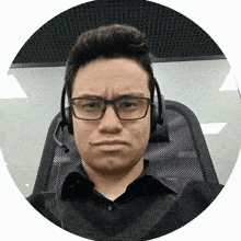 a man wearing glasses and headphones makes a face