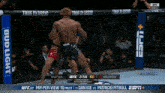two men are fighting in a boxing ring with a bud light banner behind them