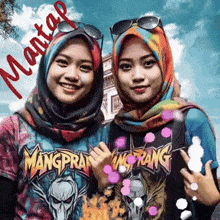 two women wearing hijabs and sunglasses are posing for a picture with mantas written in red